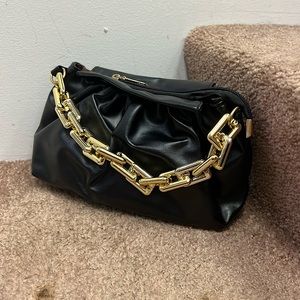 Small black clutch with gold chain handle